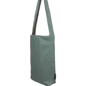 The Feel Good Bag - Chinois Green by Tinne+mia is a plain, rectangular shoulder bag with a long strap, crafted from smooth fabric. It stands upright and empty against a white background. Gate21.ee