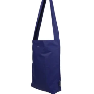The Feel Good Bag - Sodalite Blue is a minimalist rectangular tote with a long single strap, shown hanging against a white background. This Tinne+mia bag features no visible patterns or decorations. Gate21.ee