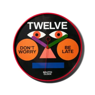 The BE LATE - Wall clock boasts a bold red rim and black face, Estonian-designed with geometric shapes and quirky text accents including TWELVE at the top—an eye-catching piece ideal for any modern concept shop. Gate21.ee