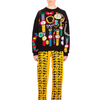 A person with short blond hair wears the Street Dealer Jumper, featuring colourful watch illustrations, paired with yellow grid-patterned trousers and red feathery shoes, standing against a plain white background. Gate21.ee