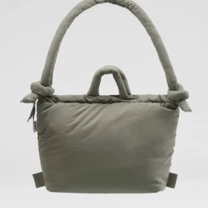The Ona Soft Bag - Sage is a soft, light grey padded tote with two handles—one short, one long and knotted—highlighting Estonian design. Ideal for Tallinn shopping or visiting your favourite concept store. Shown on a plain white background. Gate21.ee
