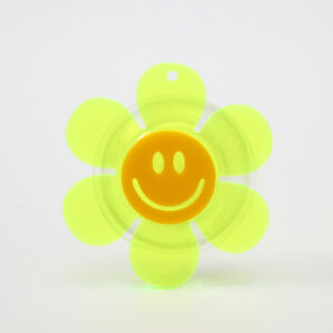 The Flower Popsockets - KÕIK features a yellow plastic smiley face and six translucent petals, displayed on a plain white background—an eye-catching accessory for any concept shop or shopping adventure in Tallinn. Gate21.ee