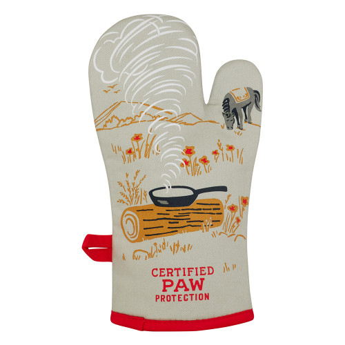 The “Boss kitty - Oven Glove” is a beige glove with red trim, showcasing a charming printed scene of a frying pan on a log with steam rising, surrounded by flowers and an adorable dog in the background. At the bottom, “CERTIFIED PAW PROTECTION” is printed in red, capturing the whimsical charm that BlueQ oven gloves are known for. Gate21.ee
