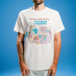 A person wearing a Burn Tee - Bone, an off-white t-shirt featuring a cartoon illustration of cats and aliens reading books with the text The Rip and Dip Family STORYBOOK FAVOURITES By Nerm & Jerm. Gate21.ee