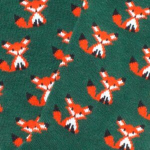 Dusk Fox - Knee-high Socks: Green fabric featuring orange cartoon foxes with curled tails, black ear tips, and white markings—ideal for those who love playful patterns. Gate21.ee