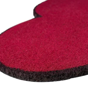 A close-up of the Doormat - "Heart": a red, heart-shaped mat with a textured surface and black edging on a white background—an ideal accent beside your handheld fan for hot summer days. Gate21.ee