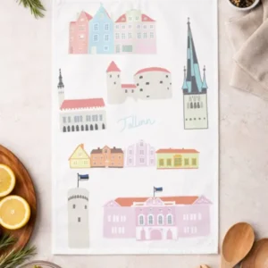 A Köögirätik – Vanalinn tea towel with Tallinn landmarks lies flat on a light worktop among cooking essentials, while a New Rebels small rucksack in the corner hints at upcoming travel and culinary adventures. Gate21.ee
