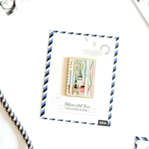 The Magnet – Tallinna vanalinn is displayed on an airmail envelope card, with a rope, part of a photo, a New Rebels small rucksack, and other small items arranged on a white surface. Gate21.ee