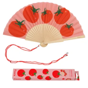 The "Tomatoes" fan features a pink paper leaf with red tomato and green stem designs, a wooden frame, red wrist strap, and comes in a matching pink box decorated with tomato illustrations and the fisura brand name—perfect for hot summer days. Gate21.ee