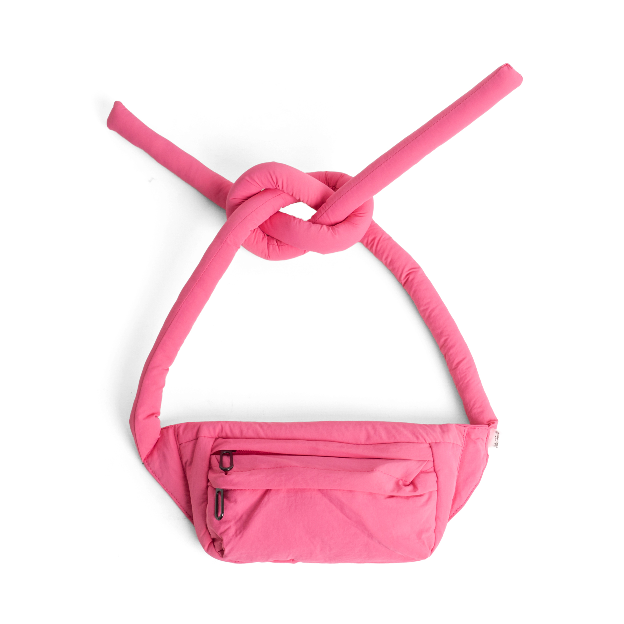 A red Knotflex Pack waist bag with long padded straps tied in a loose knot at the top, set against a plain white background. It features a zipped front pocket. Gate21.ee