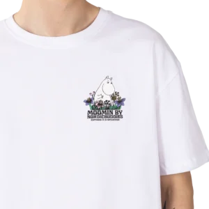 A person wearing the Moomin Ts - Meadow, a white T-shirt with a small Moomin character, flowers, and the text “MOOMIN BY NORDICBUDDIES HAPPINESS IS AN ATTITUDE” on the left chest. Gate21.ee