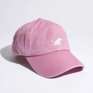 The Moomin Cap is a light pink baseball cap featuring a small white embroidered dog logo on the front, shown against a white background—ideal for pairing with your favourite Moomin keyrings. Gate21.ee