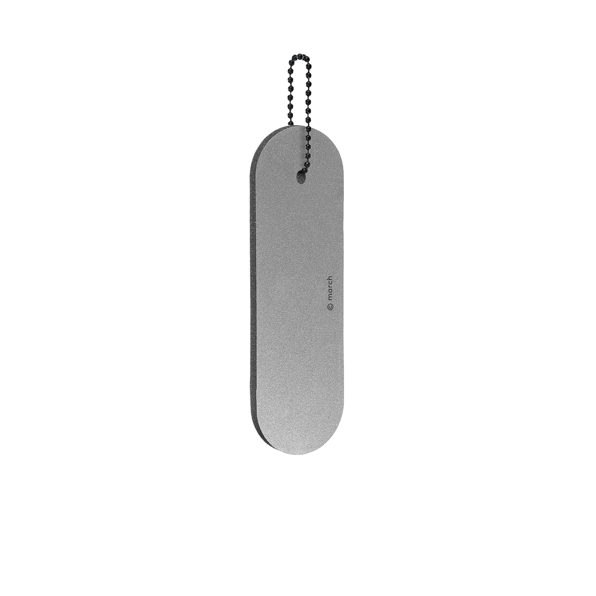 The Dangle - Long - Grey is a flat, oval-shaped metal reflector with a small hole at one end, attached to a short ball chain and shown against a white background. Gate21.ee
