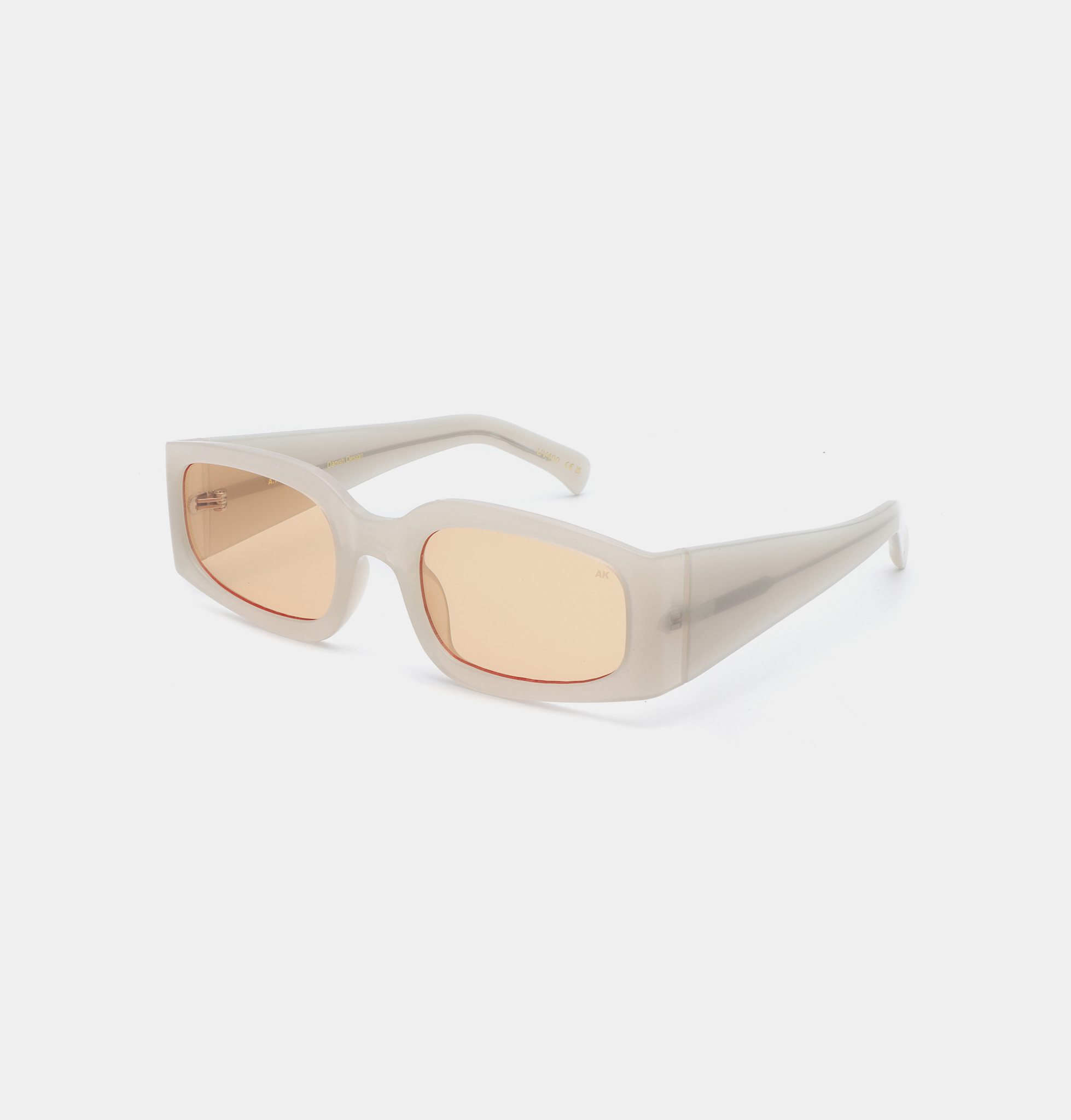 Rectangular ALEX sunglasses by A. Kjærbede, featuring thick, grey transparent frames and light brown-tinted lenses, displayed on a plain white background. Gate21.ee