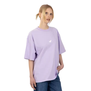 A person with fair hair in a ponytail wears the Moomin Ts - White (Copy), a loose-fitting T-shirt with a small graphic on the chest, paired with blue jeans and standing against a plain white background. Gate21.ee