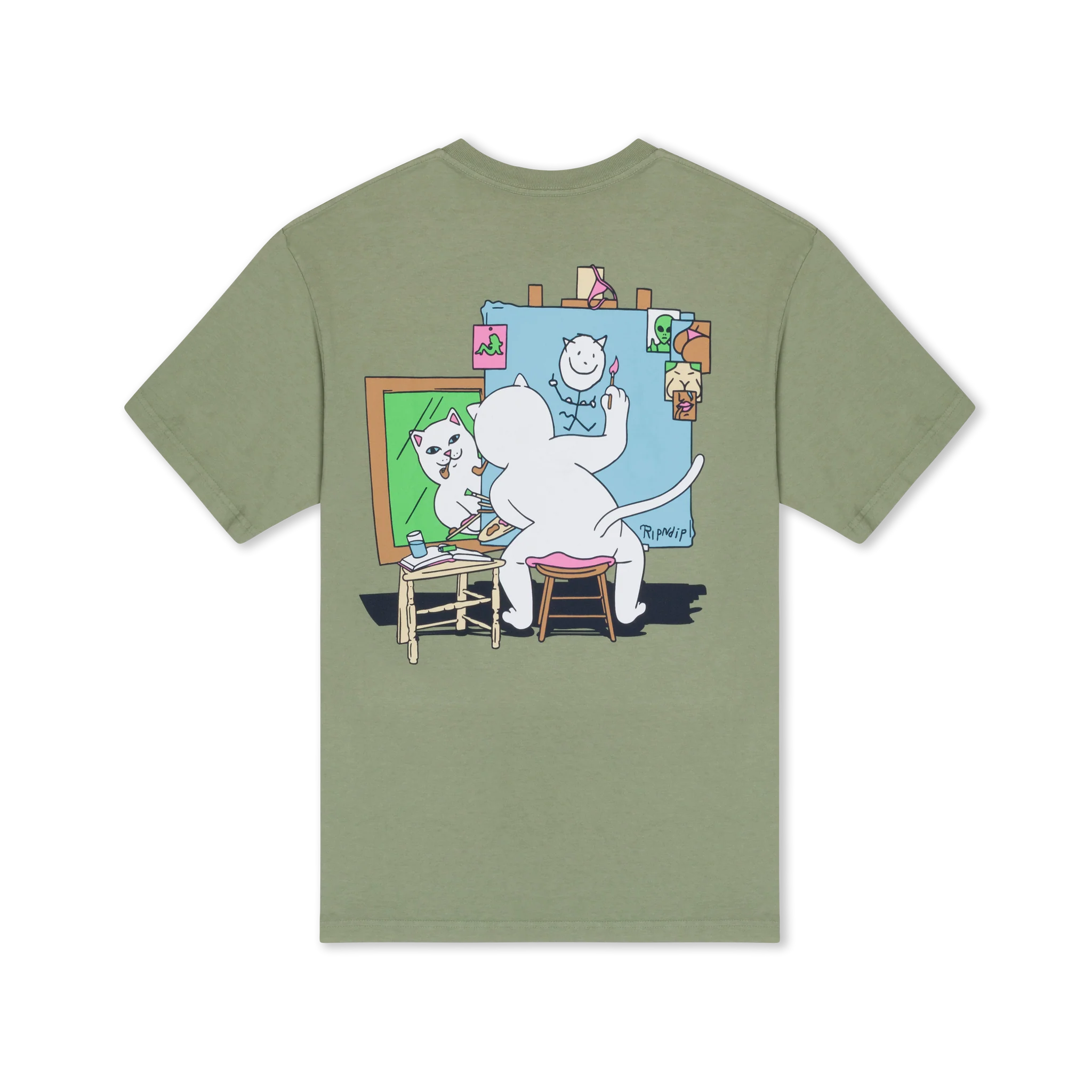 The black Stop Being a Pussy Tee by RIPnDIP features a white cartoon cat on the back, sitting on a stool and painting its self-portrait at an easel, surrounded by photos and drawings pinned to a blue board. Gate21.ee
