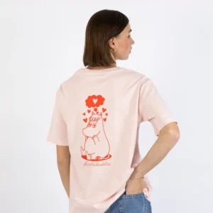 A person with short brown hair is wearing the Moomin Ts - Hiking Club (Copy), a pale pink shirt featuring a red line drawing of a hippo-like character, a heart-shaped thought bubble, and "hidebuddies" printed on the back. Gate21.ee