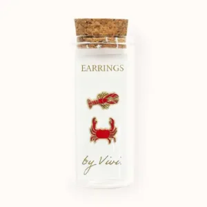 A clear glass phial with a cork lid contains two earrings called Tennis earrings by Vivi (Copy). Text on the phial reads Earrings by Vivi. Gate21.ee
