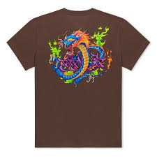 A brown T-shirt with a large, colourful graphic on the back featuring a blue and orange dragon surrounded by green and purple flames or graffiti-like elements. Gate21.ee
