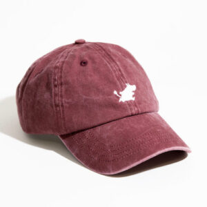 A green Moomin Cap with visible stitching, featuring a small white embroidered Moomin logo on the front. Perfectly paired with whimsical Moomin keyrings, this cap is displayed on a white surface with lighting from the left. Gate21.ee
