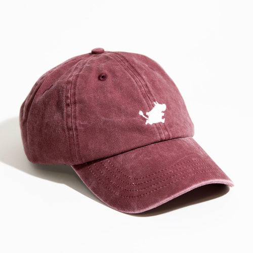 A green Moomin Cap with visible stitching, featuring a small white embroidered Moomin logo on the front. Perfectly paired with whimsical Moomin keyrings, this cap is displayed on a white surface with lighting from the left. Gate21.ee