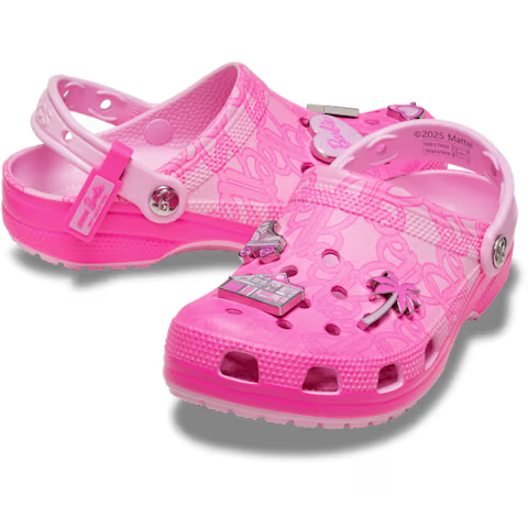 The Crocs Barbie® Classic Clog is a pair of pink Crocs embellished with Barbie-themed charms like a palm tree, a car, and the Barbie logo. These clogs feature ventilated holes, adjustable straps, and a patterned surface. Gate21.ee