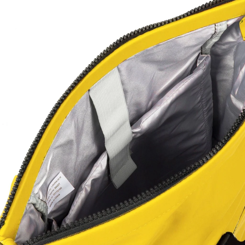 Open yellow New York Rolltop Rucksack with a grey inner lining, an inner pocket, and a visible white fabric label. A grey strap is attached inside. The zip is partially open, showing the contents and compartments within the bag. Gate21.ee