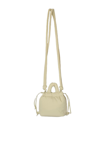 A compact, butter yellow Micro Ona Soft Bag with a long, slim shoulder strap and two short handles, displayed against a plain white background. Gate21.ee