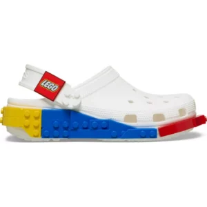 The Crocs™ 4LW System Clog in white is a clog-style shoe that showcases colourful LEGO brick designs on the sole, featuring blue, yellow, and red brick-like details, along with a red LEGO-branded heel strap. Gate21.ee