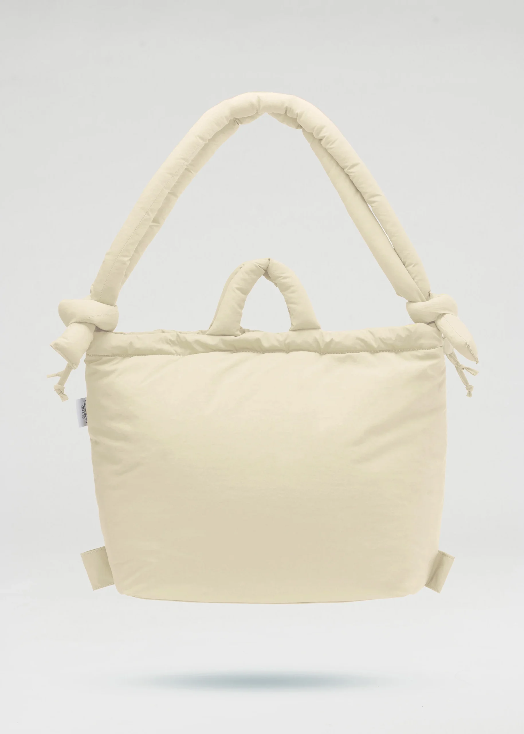 A chocolate-coloured, rectangular padded tote bag—specifically the Ona Soft Bag—with short handles and long, knotted shoulder straps, shown against a plain light grey background. Gate21.ee