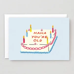 HaHa! - Greeting Card featuring an illustration of a rectangular birthday cake with five lit candles, pink and blue icing, and the message “HAHA YOU’RE OLD” written in red icing on top. Gate21.ee