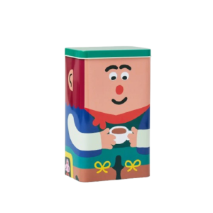 The Kitchen Storage / Coffee Tin - Lil’Guy is a rectangular tin container featuring a vibrant cartoon illustration of a person with a red nose, black eyebrows, and a red scarf holding a cup on the white front. Perfect for gifting or keeping as a fun coffee tin, it comes with a green lid and whimsical design. Gate21.ee