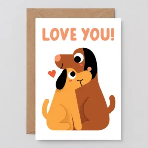 Wrap your message with the Love You Dogs! - Greeting Card, featuring two cuddling cartoon dogs (brown & yellow) under a red heart, bold orange “LOVE YOU!” on top, and includes a brown envelope. Gate21.ee