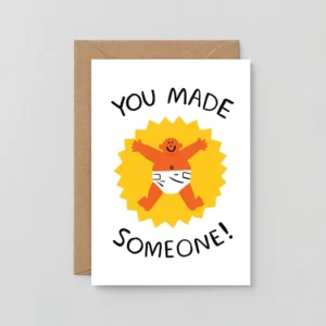 The Made Someone! - Greeting Card features “You Made Someone!” above and below a cartoon baby in a nappy on a yellow starburst background, displayed with a brown envelope. Gate21.ee