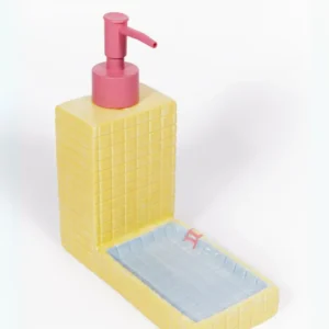 The Pool - Soap Dispenser is a yellow, rectangular soap dispenser with a pink pump, attached to a matching yellow tray with a light blue base. Both pieces feature a textured square pattern, and the tray is adorned with a red Gemini zodiac symbol—perfect for L’Expressionist gifts. Gate21.ee