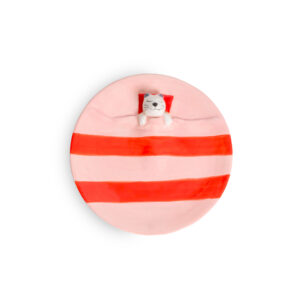 A pink ceramic Loving Cat - Jewellery Dish with red horizontal stripes, featuring a sculpted cat head resting on a red cushion. Gate21.ee